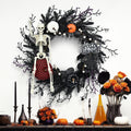 Couronne d’Halloween avec citrouille, crâne et branches décoratives